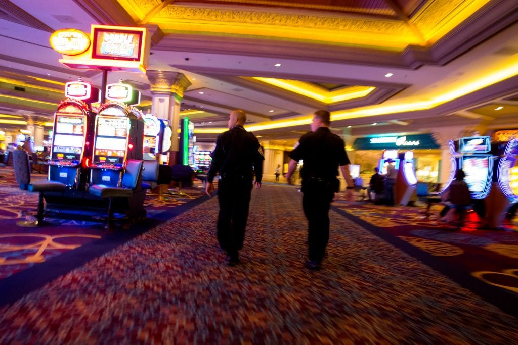 two security guards walking in a casino room