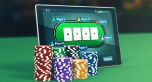 a tablet with poker chips near it 