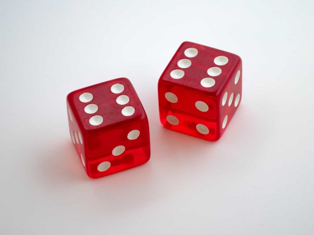 two red dices laying on a white table