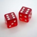 two red dices laying on a white table