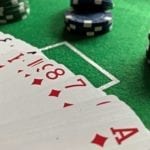 picture of green poker table with poker cards